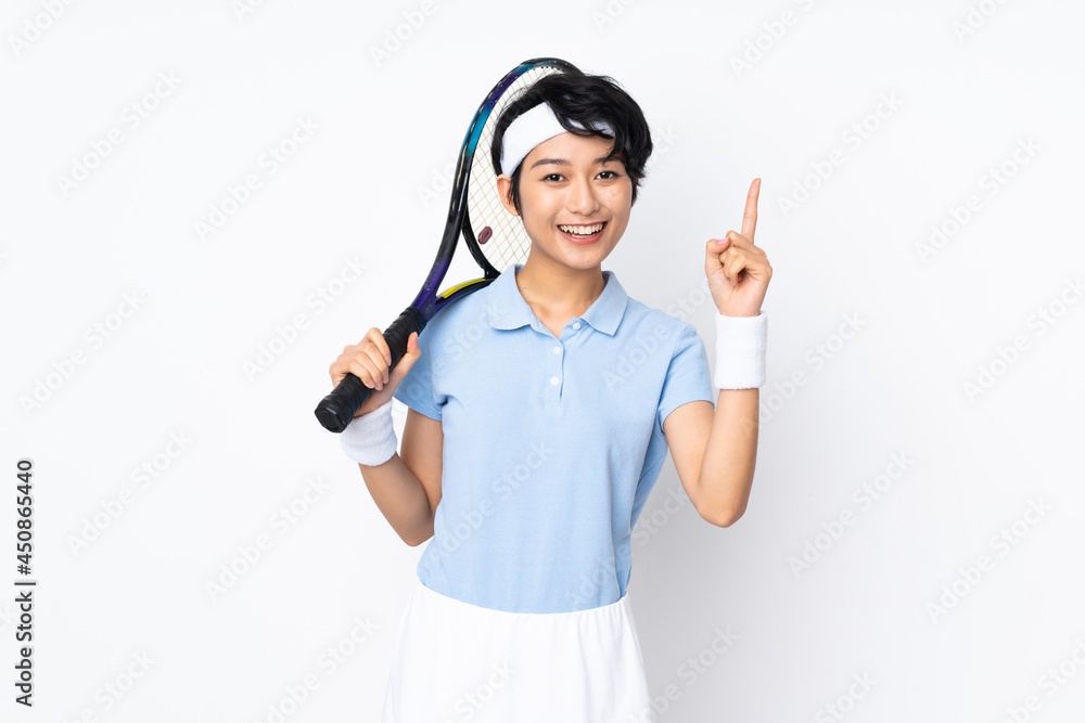 Young Vietnamese tennis player woman over isolated white wall playing tennis and pointing up Young Vietnamese tennis player woman over isolated white wall playing tennis and pointing up
