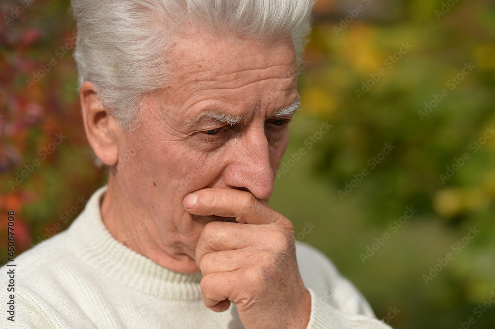 Close up portrait of thoughtful senior man outdoors Close up portrait of thoughtful senior man outdoors