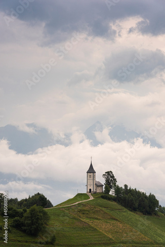 St Primoz Church in Jamnik Sovenia on Hill Top In Clouds