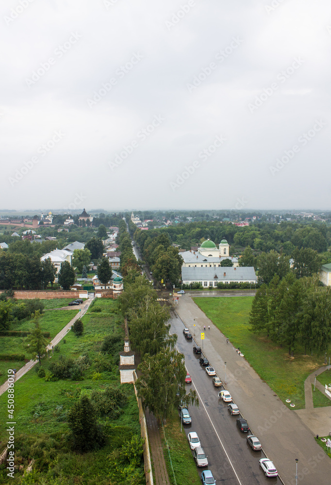 SUZDAL, Vladimir Region, RUSSIA-AUGUST, 11, 2021: beautiful landscape-panoramic view of the roofs of the old city and the green foliage of trees on a cloudy summer day