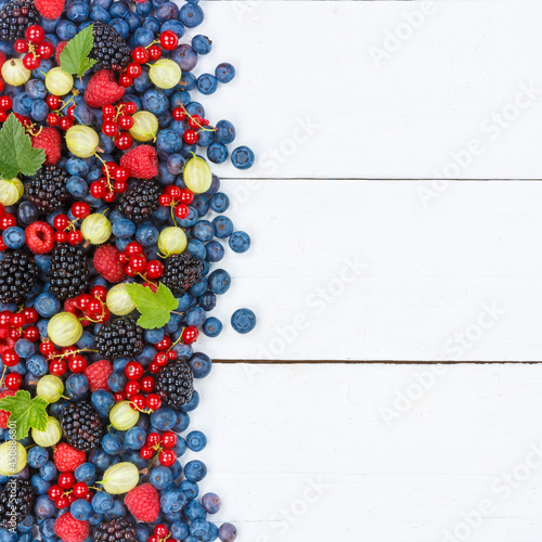 Berries fruits berry fruit strawberries strawberry blueberries blueberry with copyspace copy space square on wooden board