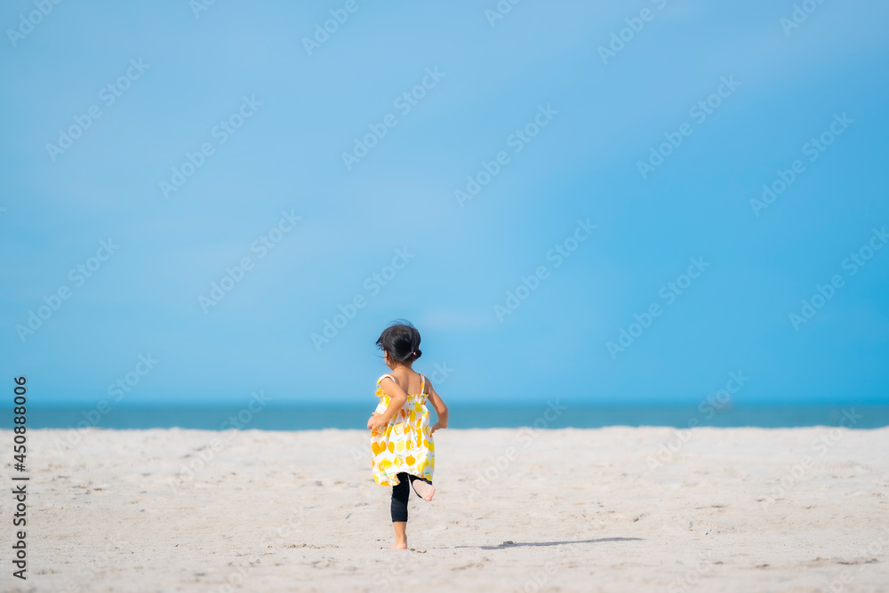Happy child running on white soft sand beach during summer day. Happy child running on white soft sand beach during summer day.
