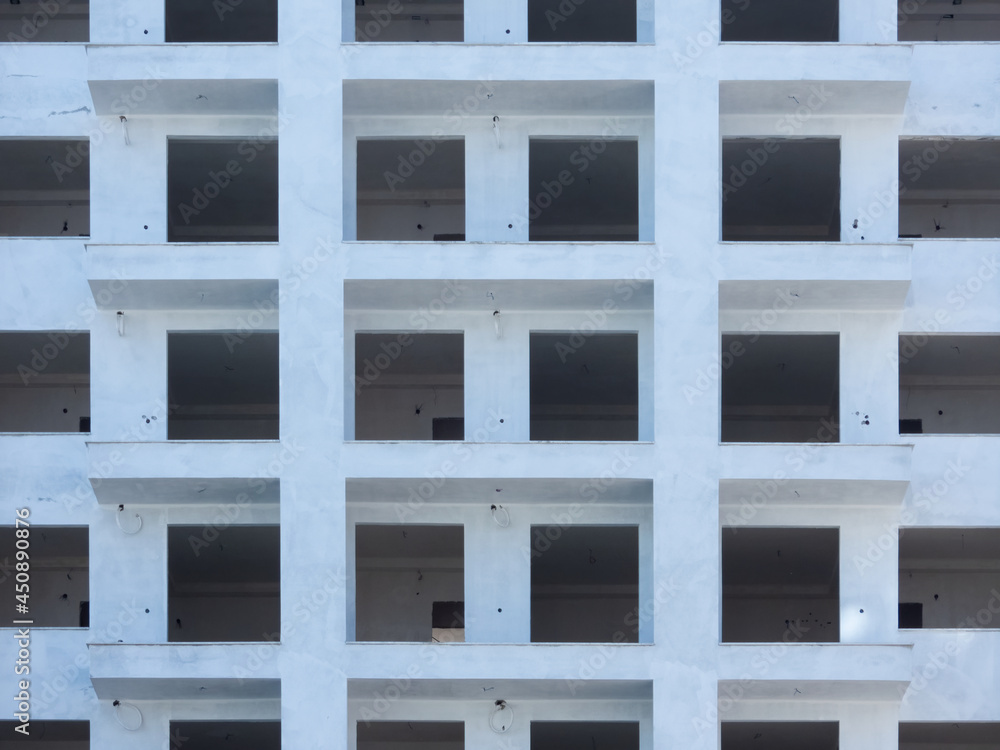 Facade of the high-rise apartment building under construction Facade of the high-rise apartment building under construction