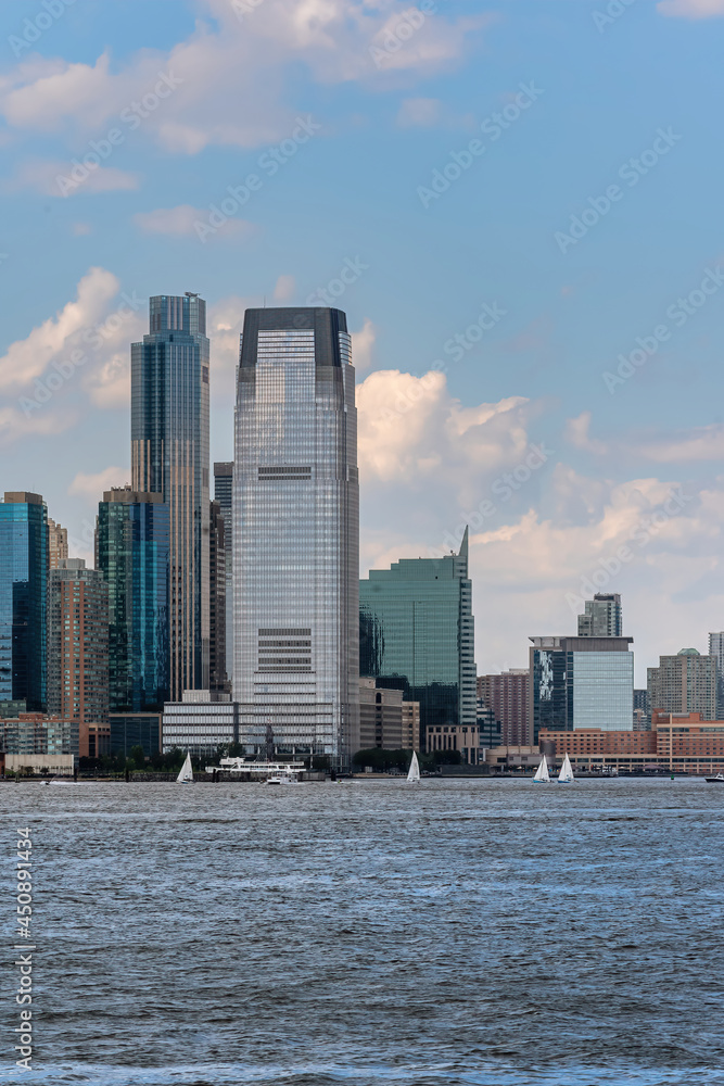 Jersey City, NJ - USA - July 30, 2021: Vertical view of Jersey City's Hudson River waterfront, from Exchange Place to Newport, is known as Wall Street West, featuring the Goldman Sachs Tower.