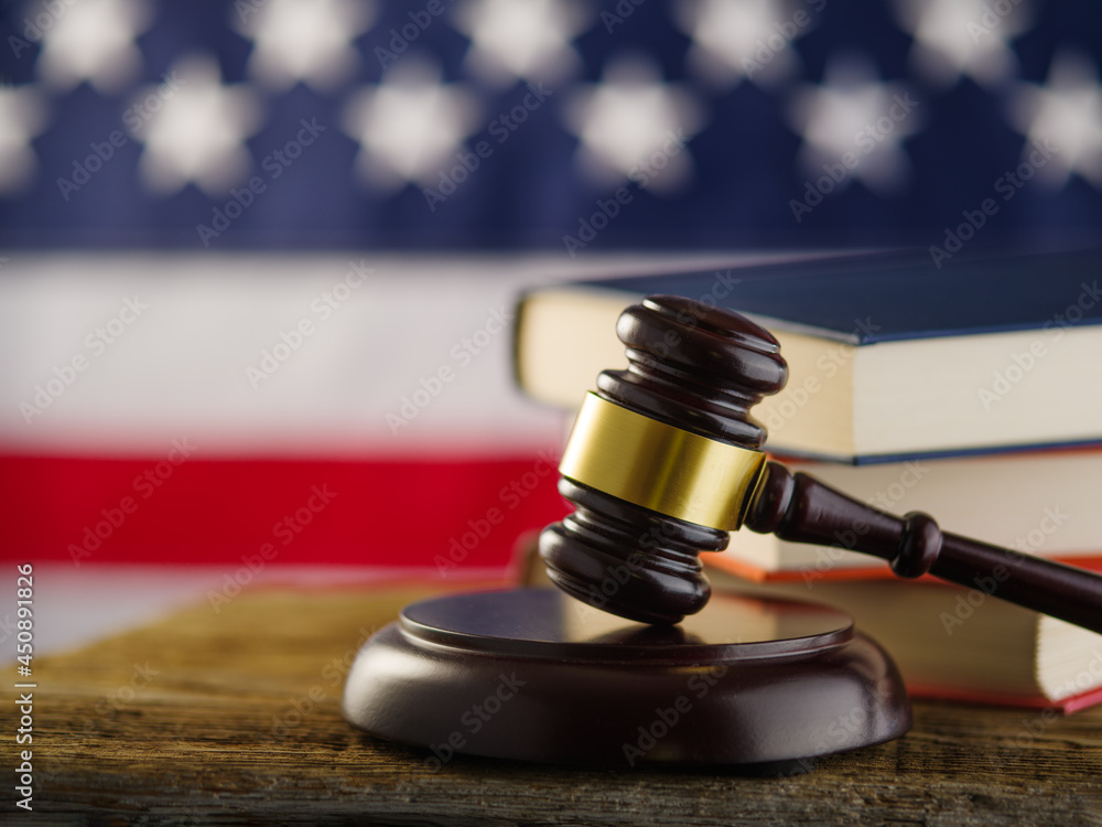 Judge's gavel, American Constitution, American flag. Focusing on the foreground. Justice, legality, human rights. Advertising business, poster, banner. Color image.