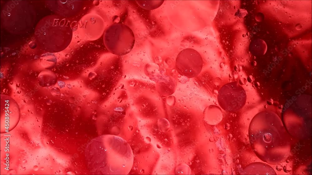 Top-down view of oil bubbles moving over different layers on the water surface. Oil drops on a water surface abstract background Top-down view of oil bubbles moving over different layers on the water surface. Oil drops on a water surface abstract background