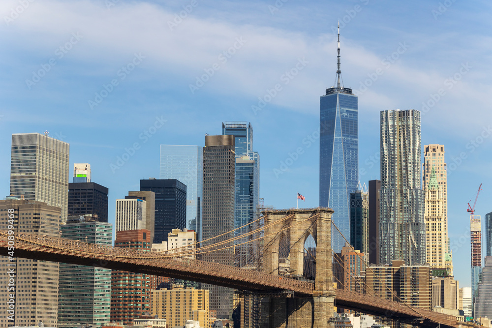 Cityscape of Brooklyn Bridge and Lower Manhattan skyscraper from beach of Brooklyn Bridge Park on June 18, 2021 in Brooklyn New York City.