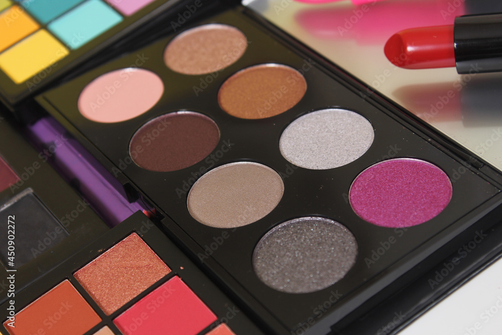 Brightly Colored Cosmetic Pigment Palettes With Various Cosmetics