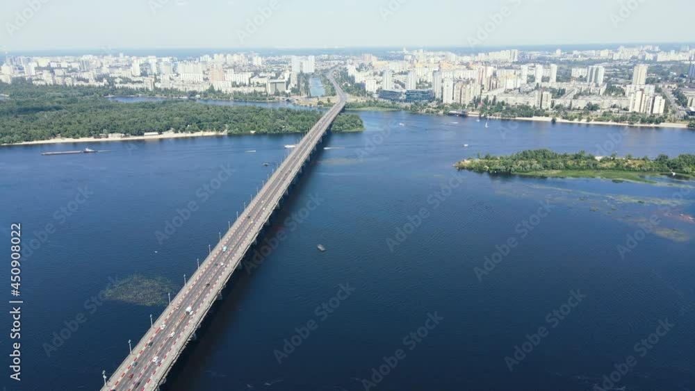 Big city view with skyscrapers and cars ride a bridge across the river Big city view with skyscrapers and cars ride a bridge across the river
