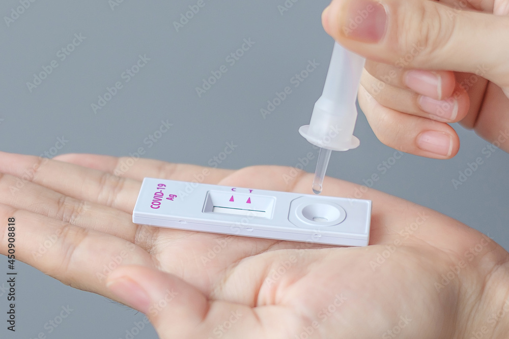 man swab COVID-19 testing by Rapid Antigen Test kit. Coronavirus Self nasal or Home test, Lockdown and Home Isolation concept man swab COVID-19 testing by Rapid Antigen Test kit. Coronavirus Self nasal or Home test, Lockdown and Home Isolation concept