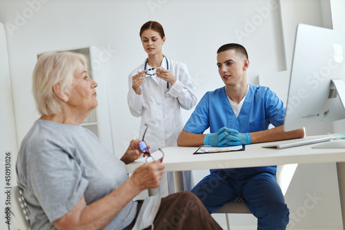 elderly woman patient at doctor s appointment and nurse in office