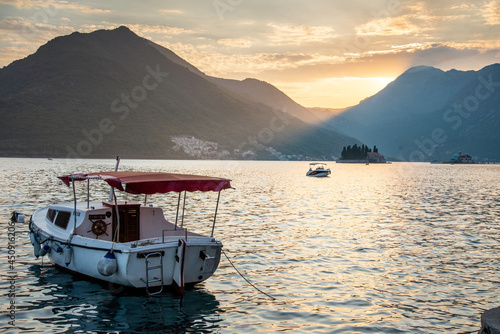 A small boat at sunset sitting on the placid waters of Perast,Montenegro.