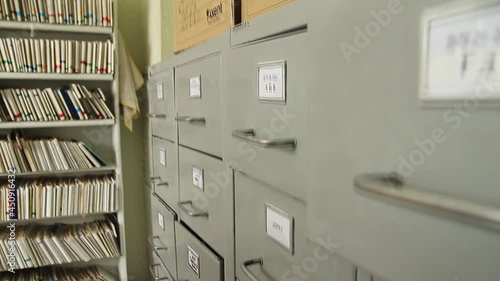 Patient Card Register in office. Health insurance folder in archive files, Medical records. catalog in clinic. Healthcare clinic. Old-fashioned medical cards on shelves in hospital