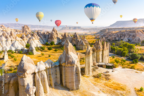 Hot air balloons flying over Love valley near Goreme village. Cappadocia. Turkey