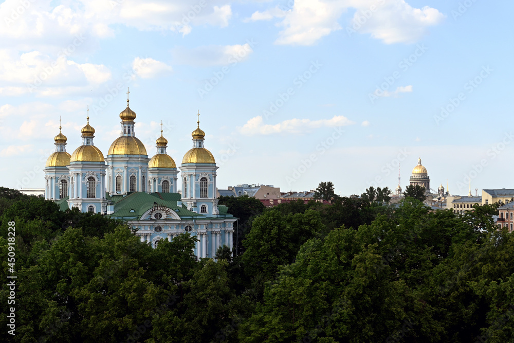 the sea Cathedral of St. Nicholas in the Baroque style in the central part of the old town against the background of a blue sky with white clouds. The architecture of the old center of St. Petersburg.