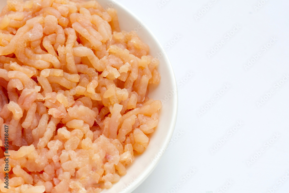 Minced meat of chicken fillet in white plate on white background. Minced meat of chicken fillet in white plate on white background.
