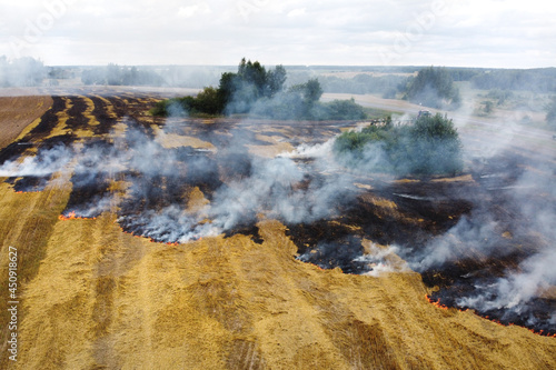 Aerial view of burning field with smoke
