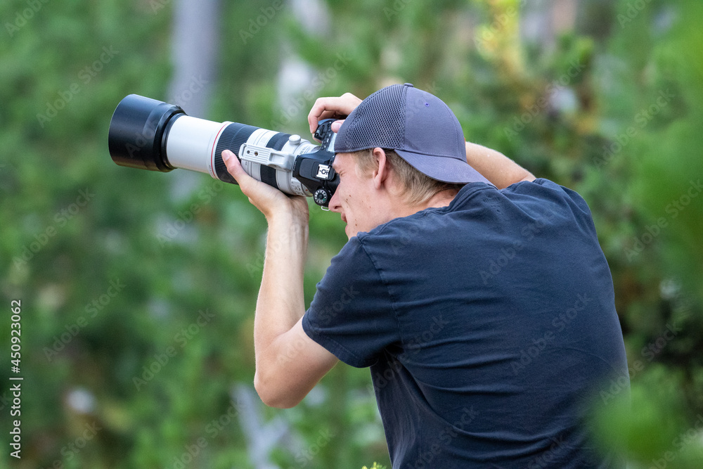 Fototapeta premium Photographer in Yellowstone National Park, Wildlife Photographer, Photographer Telephoto Lens
