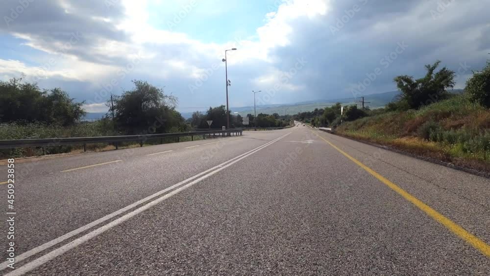View of the road from the car windshield. Scenic view of nature from inside a moving vehicle, Fast motion. View of the road from the car windshield. Scenic view of nature from inside a moving vehicle, Fast motion.