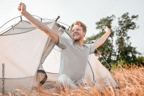 A ginger man feeling slepy and stretching photo