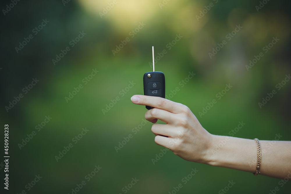 woman holding a car key
