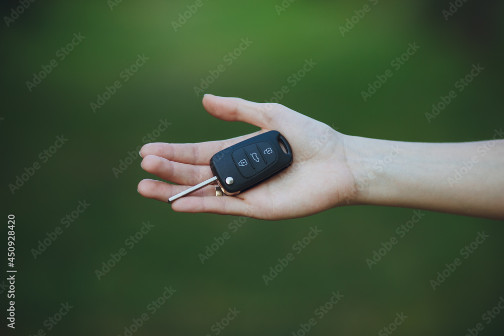 woman holding a car key