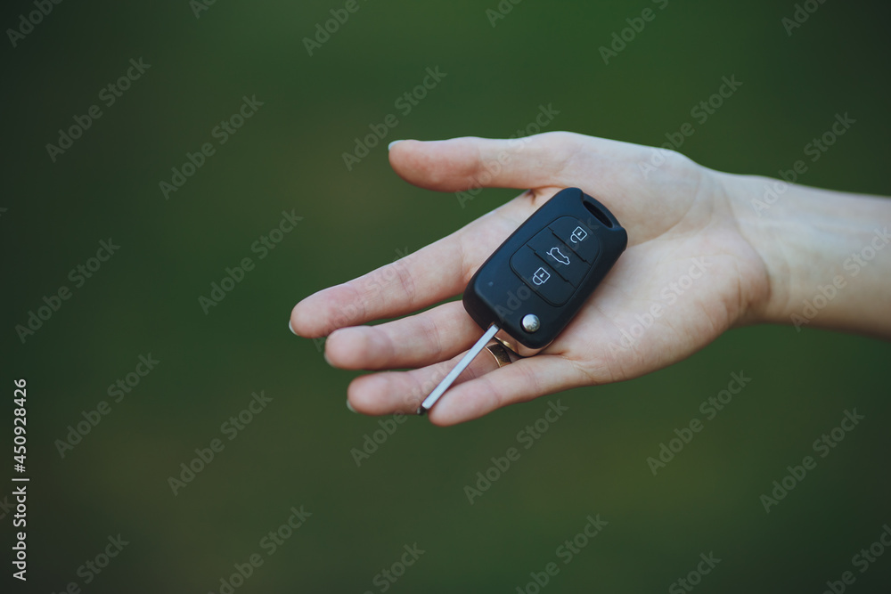 woman holding a car key
