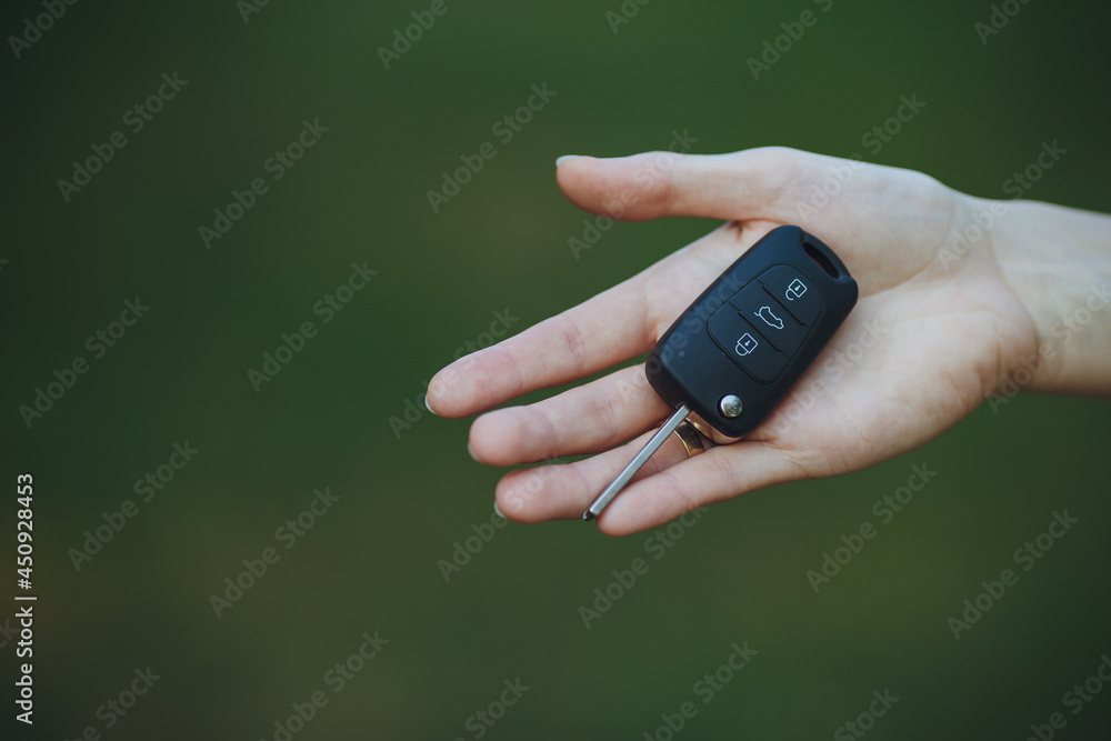 woman holding a car key