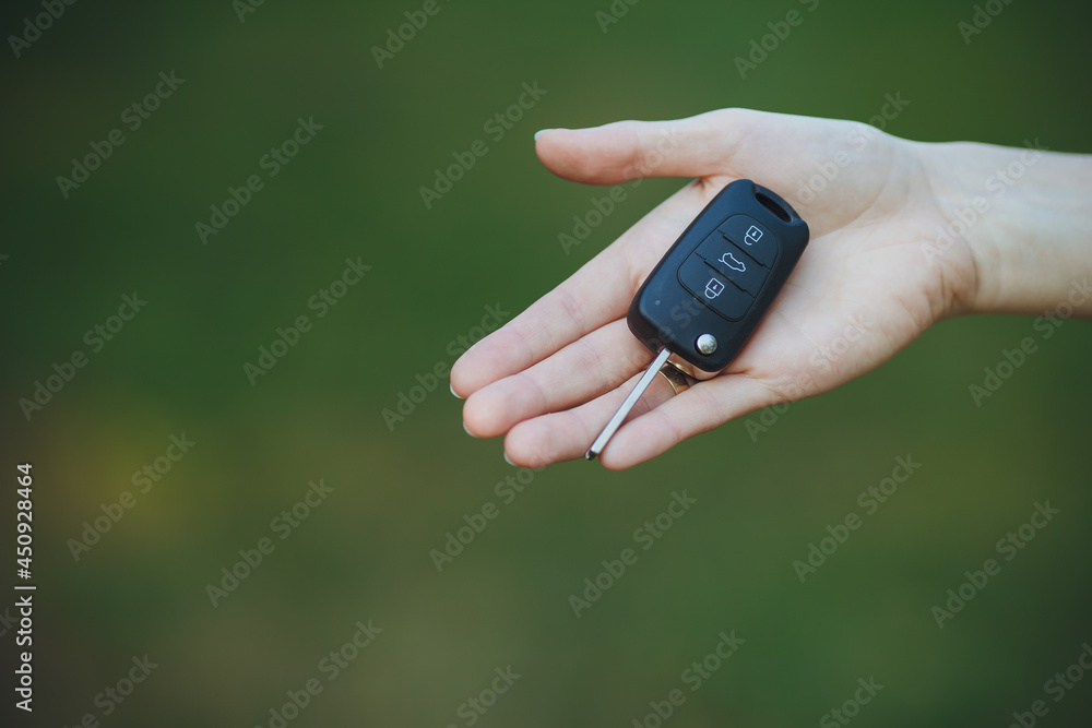 woman holding a car key