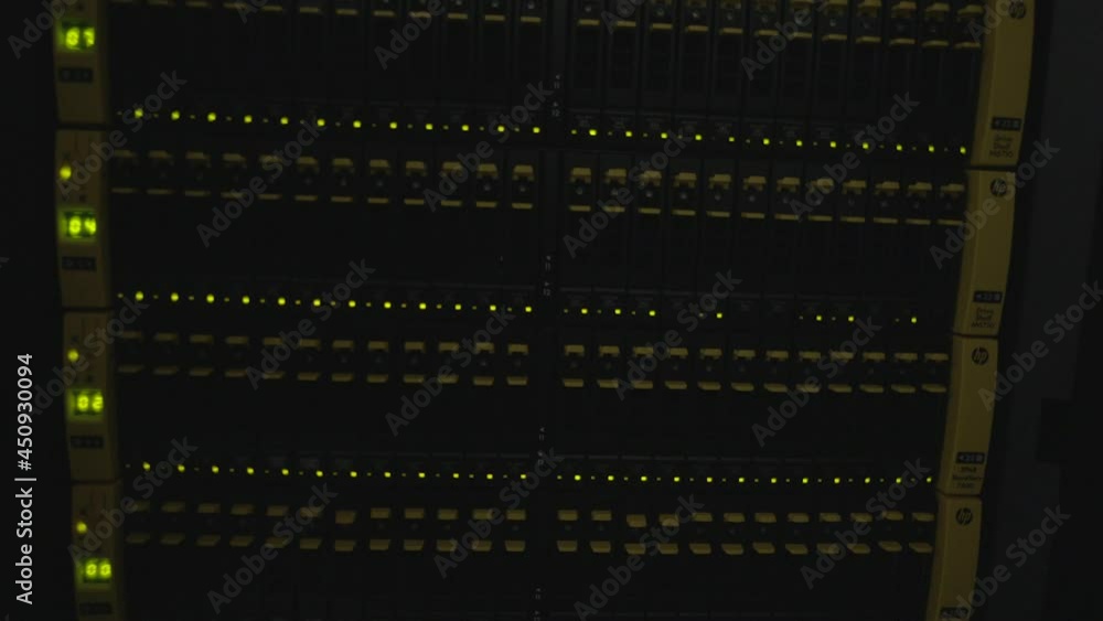 Close-up view of modern internet network switch with plugged ethernet cables. Blinking green lights on internet server. Optical server. Commutator. Flashing lights. Optical fiber. Video IP Gateways. Close-up view of modern internet network switch with plugged ethernet cables. Blinking green lights on internet server. Optical server. Commutator. Flashing lights. Optical fiber. Video IP Gateways.