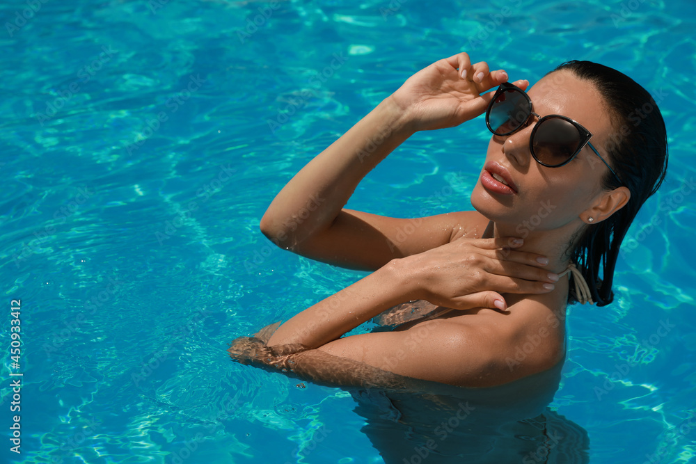 Beautiful woman wearing bikini in swimming pool