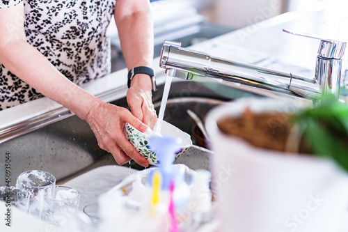 japanese senior woman washing dishes