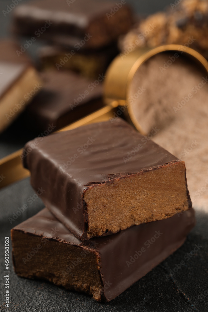 Tasty energy bar and protein powder on grey table, closeup Tasty energy bar and protein powder on grey table, closeup