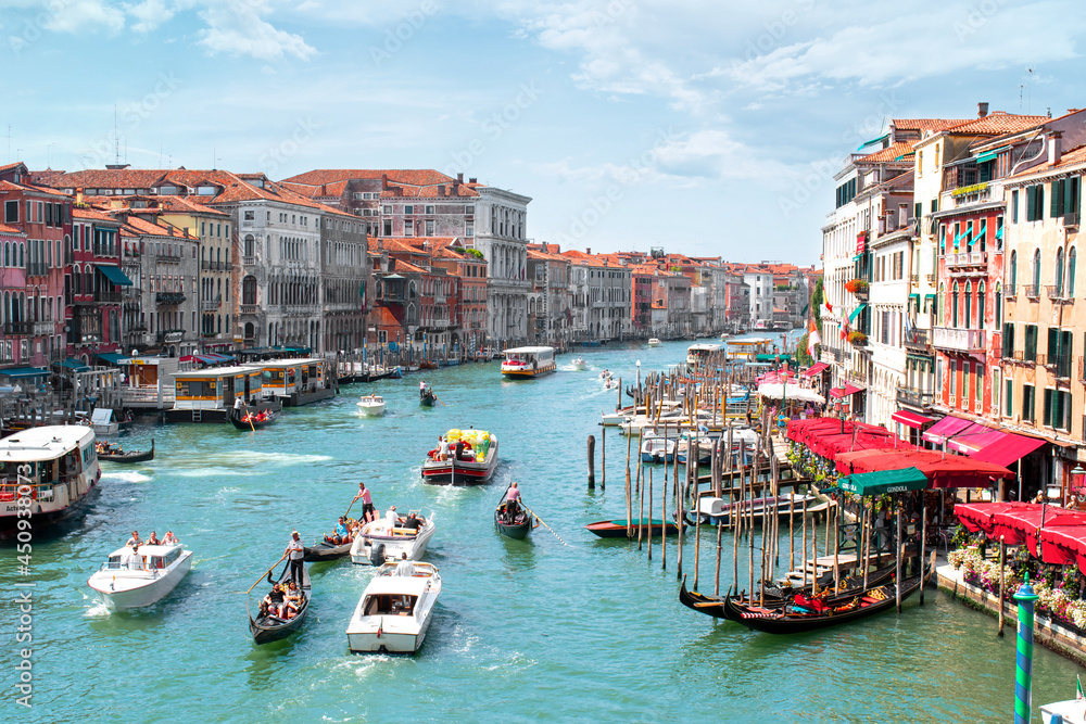 Venice, Italy, overview from Rialto Bridge to Grand Canal, boat taxi station and old houses along the canal.