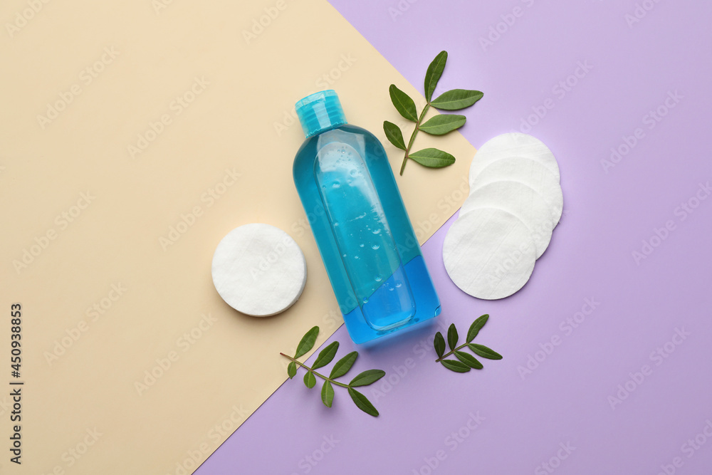 Cotton pads, leaves and makeup removal product on color background, flat lay Cotton pads, leaves and makeup removal product on color background, flat lay