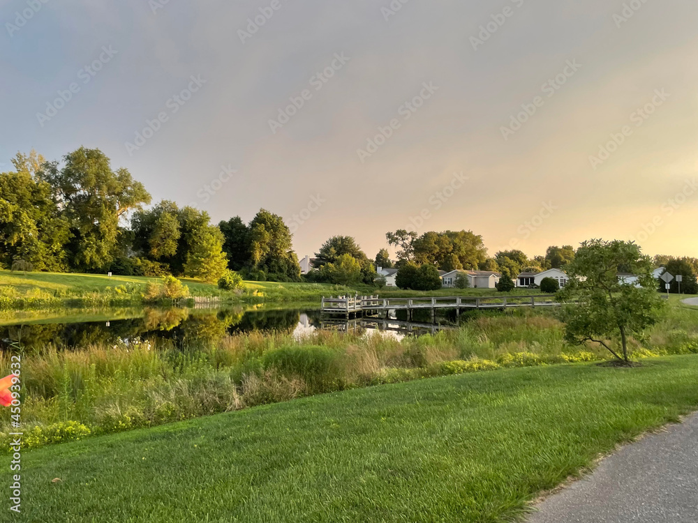 Fototapeta premium Fishing Dock Over a Pond at Sunset