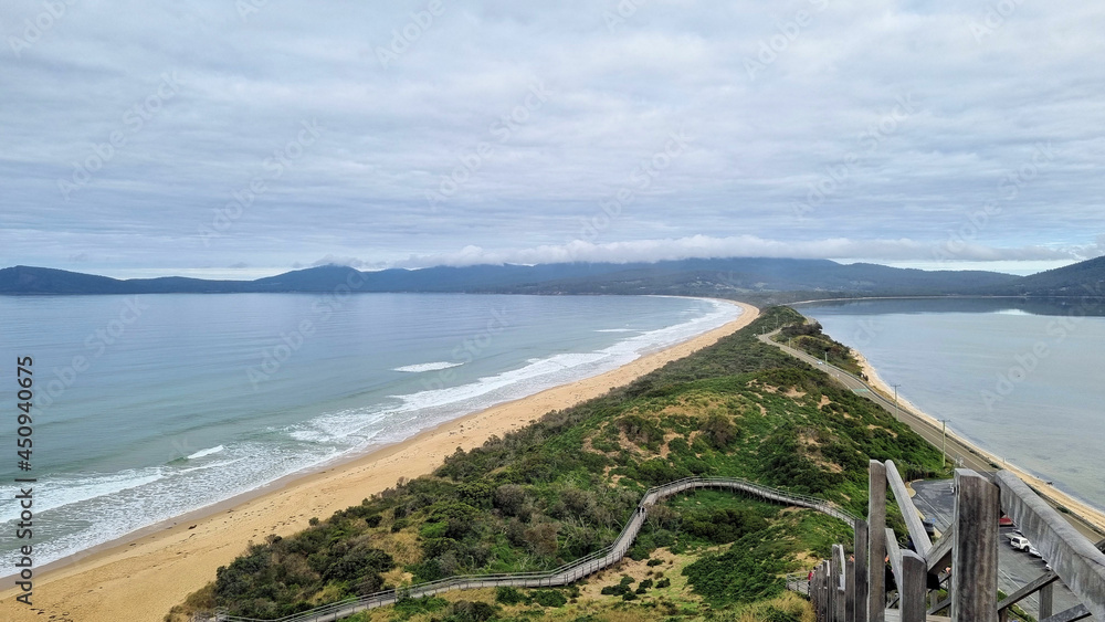 View from the lookout at The Neck Bruny Island over the beach with cloudy skies. Tasmania Australia