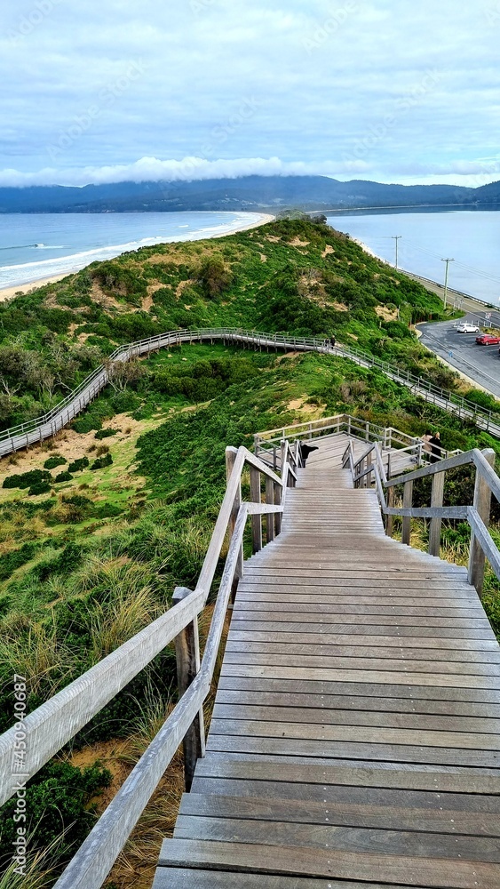 Obraz premium View from the lookout at The Neck Bruny Island over the beach with cloudy skies. Tasmania Australia. Showing the Steps up to the viewing platform