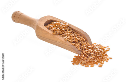 golden flax seeds in wood scoop on white background