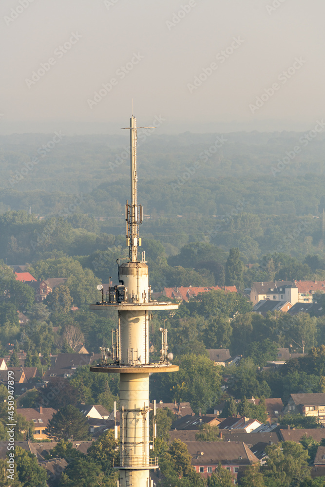 Tower, 5G mast for mobile networks and city in the background.