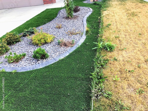 A comparison photo of a  artificial synthetic lawn beside a real natural grass in the summer.  The artificial lawn looks much nicer whereas the real lawn has died. photo