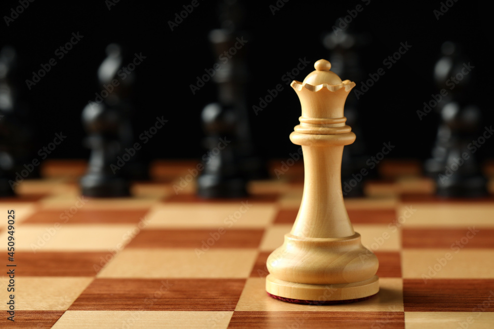 Chessboard with game pieces on black background, closeup. Space for text Chessboard with game pieces on black background, closeup. Space for text