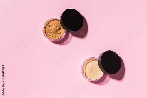 Mineral powder foundation isolated on a pink background. Eco-friendly and organic beauty products