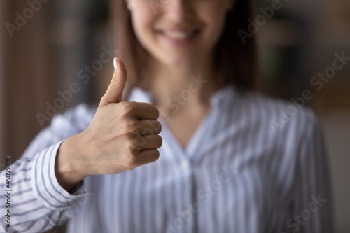 Photos Crop close up of smiling woman show thumb up give recommendation to good quality customer service