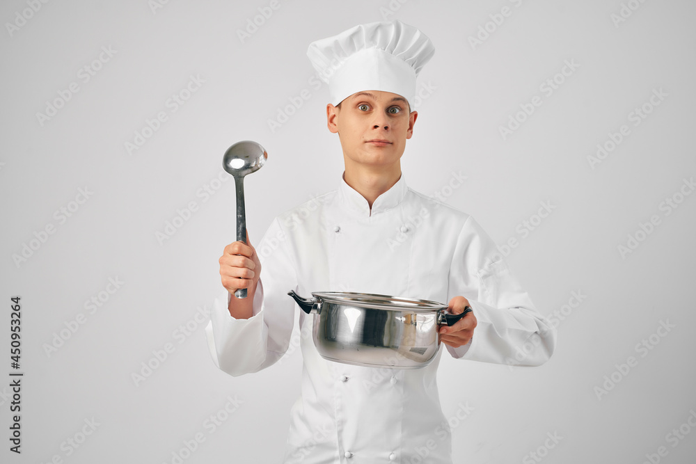 a man in a chef's uniform with a pan in his hands preparing food restaurant a man in a chef's uniform with a pan in his hands preparing food restaurant