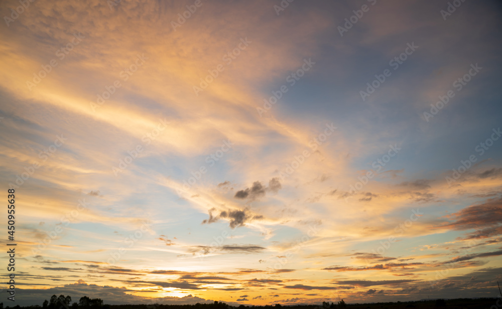 Naklejka premium Cumulus sunset clouds with sun setting down. sky with clouds and sun. sweet sky.background and space