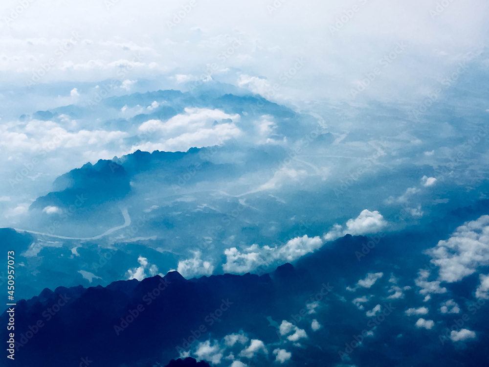 Naklejka premium Blue sky with clouds and mountains seen from above in Vietnam