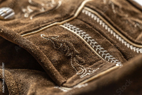 Close-up of details of a bavarian folk costume leather pants photo