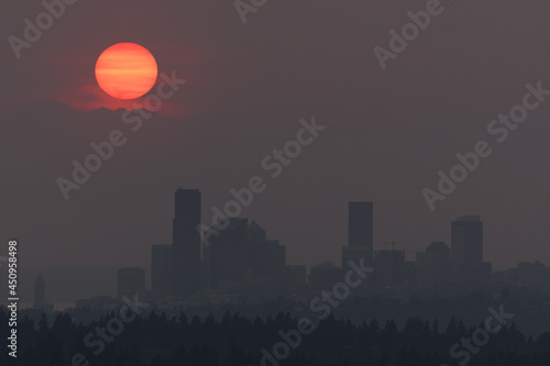 Heavy wildfire smoke surrounds Seattle with sunset behind the Olympic Mountains
