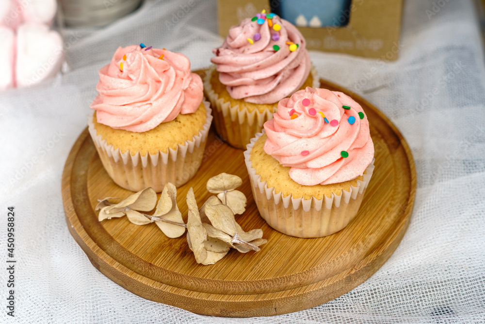 Homemade cupcakes on top of a wooden surface
